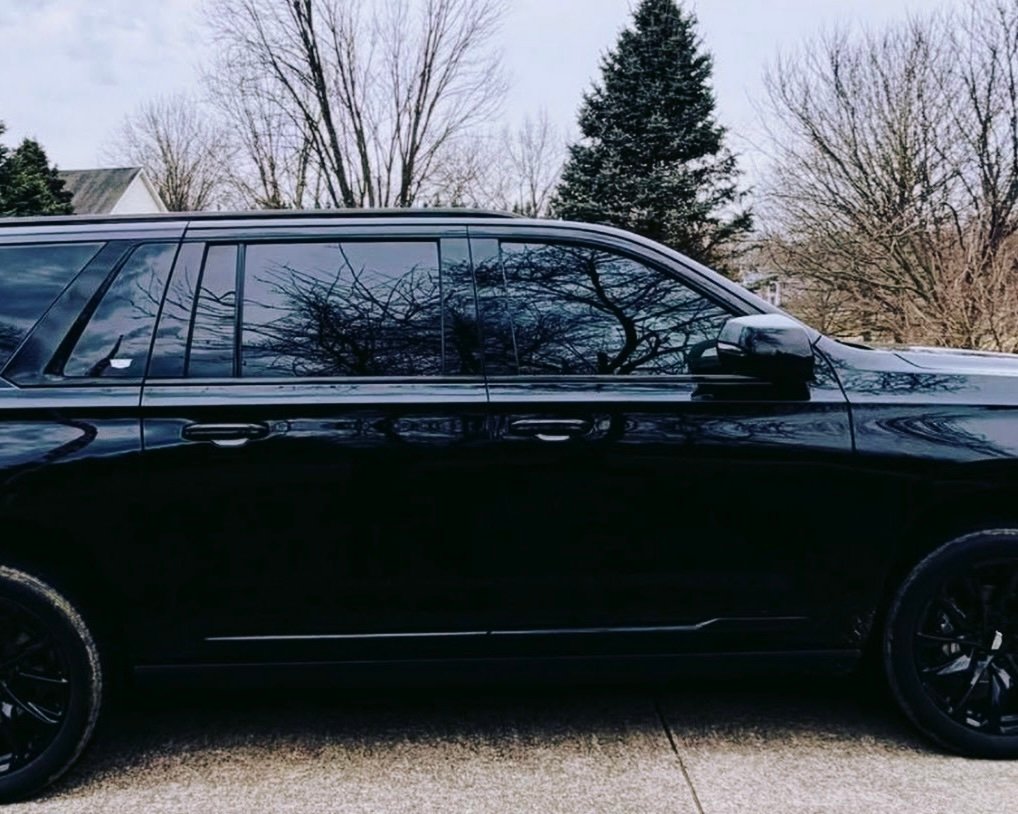 Corporate black SUV chauffeur service in downtown city